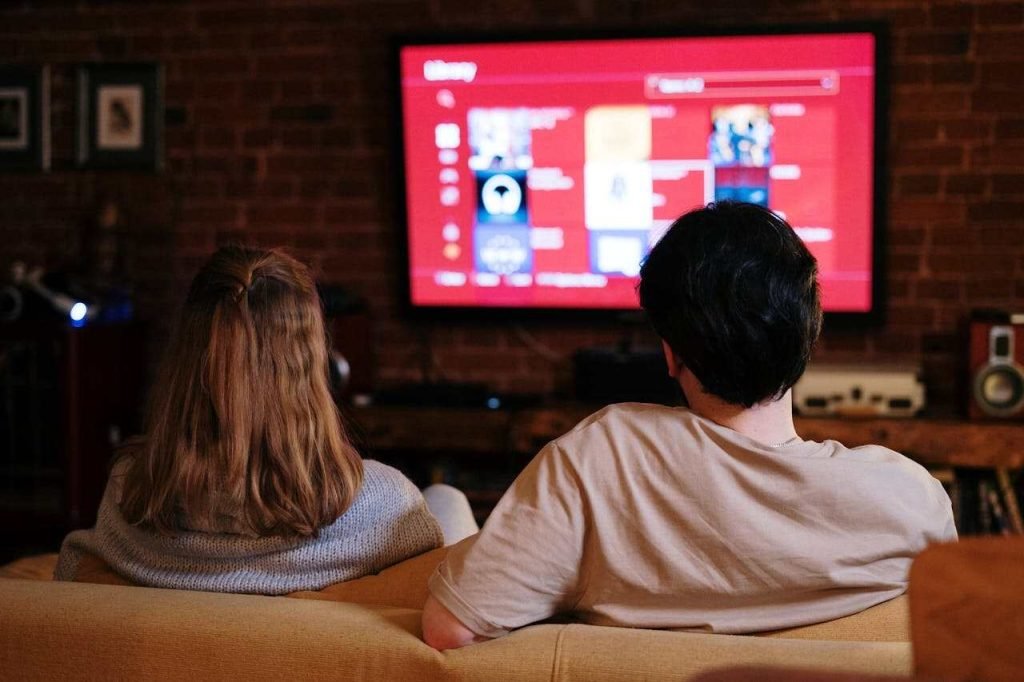 Your Gateway to Seamless Entertainment: Live TV, OTT, and More A Couple Watching TV