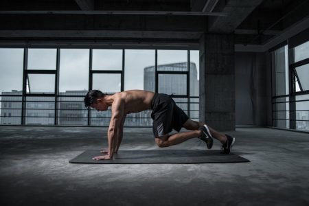 "A person performing a high-intensity interval training (HIIT) workout with vibrant energy in a gym setting, representing the benefits of this effective exercise routine.