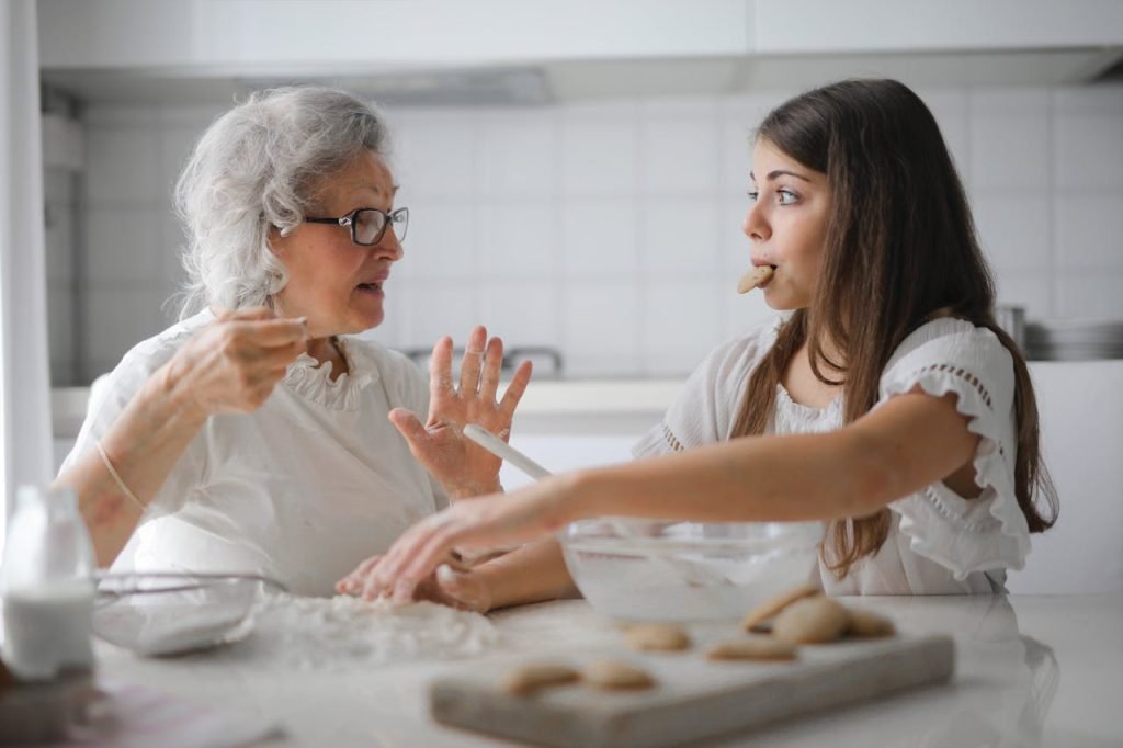 A compassionate caregiver assisting an elderly woman at home, showcasing the comfort and safety provided by home care agencies.