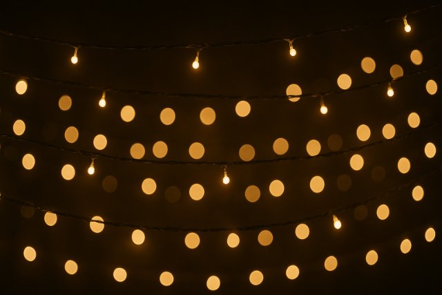 Warm fairy lights glowing in rows for festive decoration.